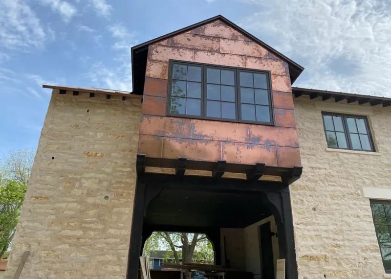 Copper metal panel facade on a stone building for Skylight Installation in Spartanburg